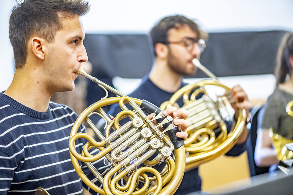 Horn players in rehearsal
